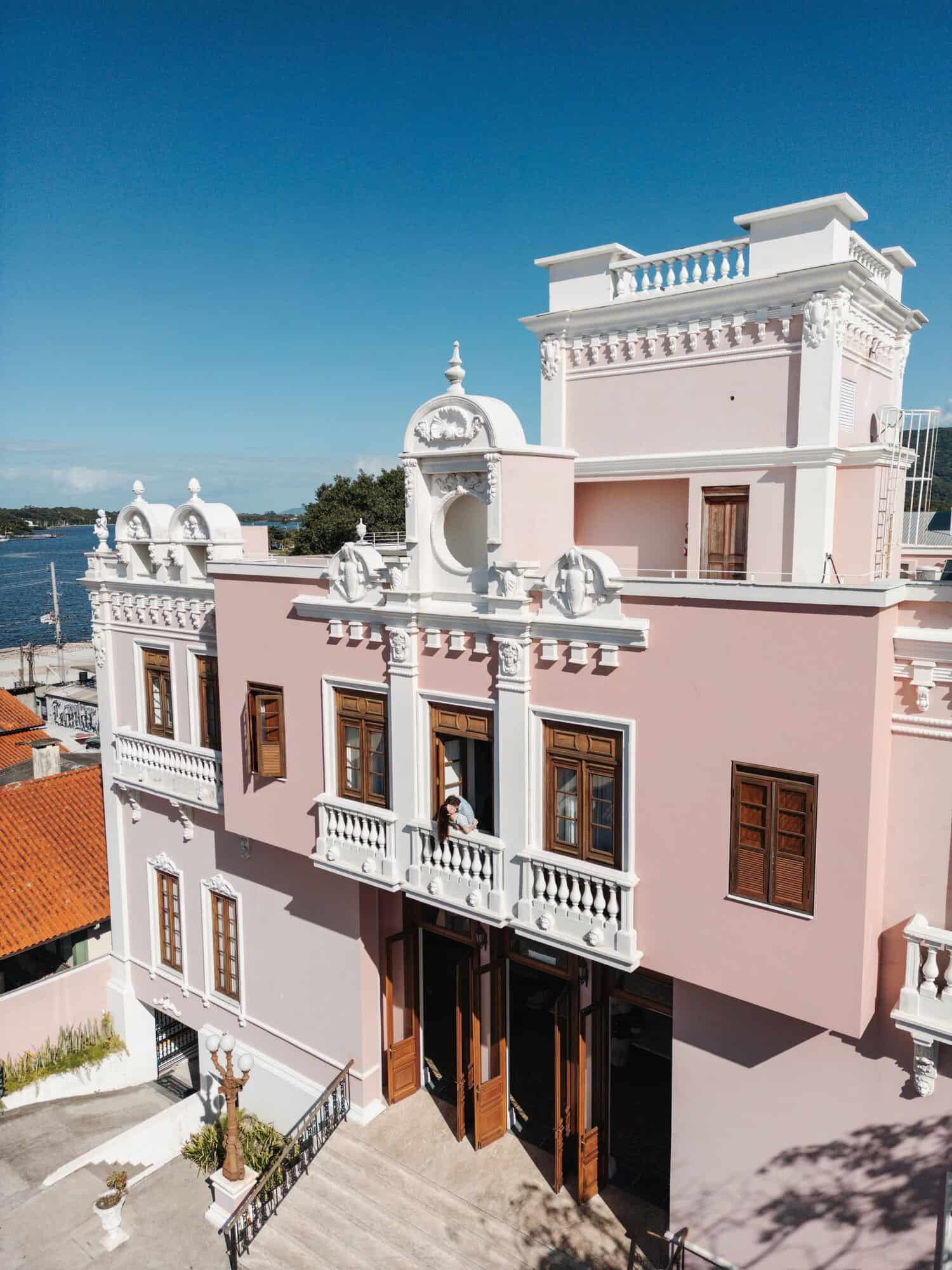 Pink exterior building with the sea in the background